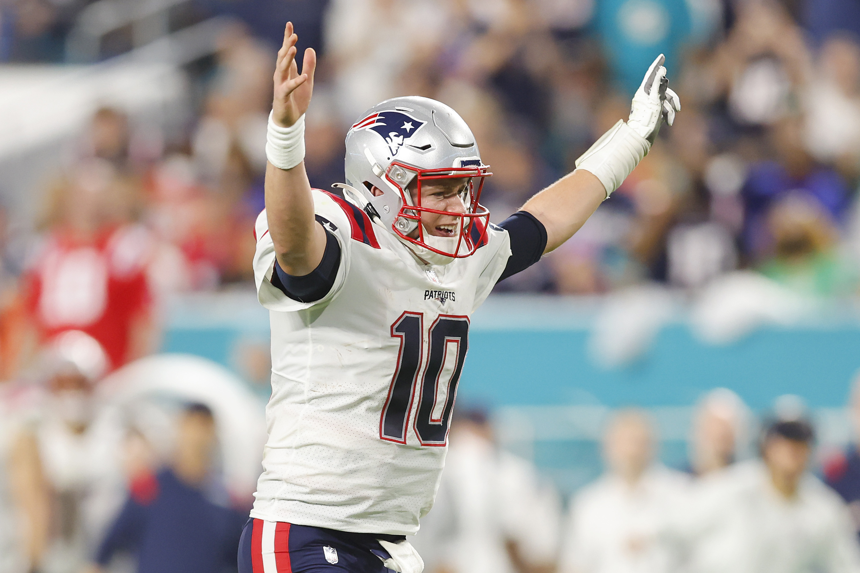 Mac Jones of the New England Patriots celebrates Damien Harris rushing for a touchdown.