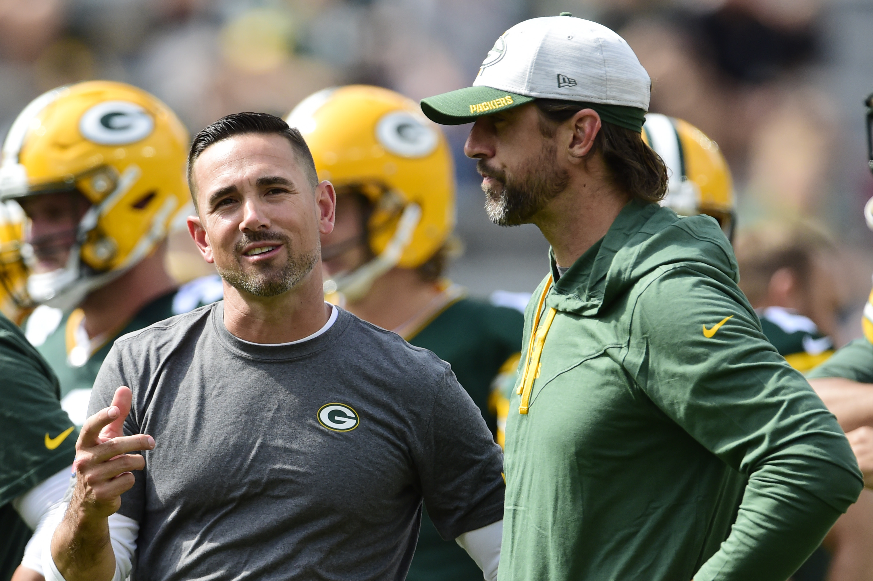 Head coach Matt LaFleur of the Green Bay Packers talks with Aaron Rodgers during warmups.