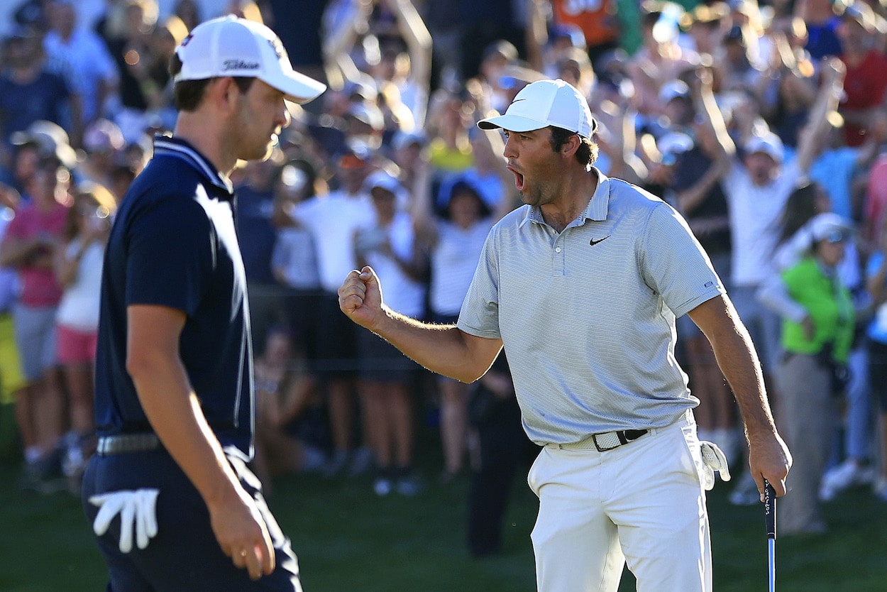 Scottie Scheffler celebrates as Patrick Cantlay looks on.