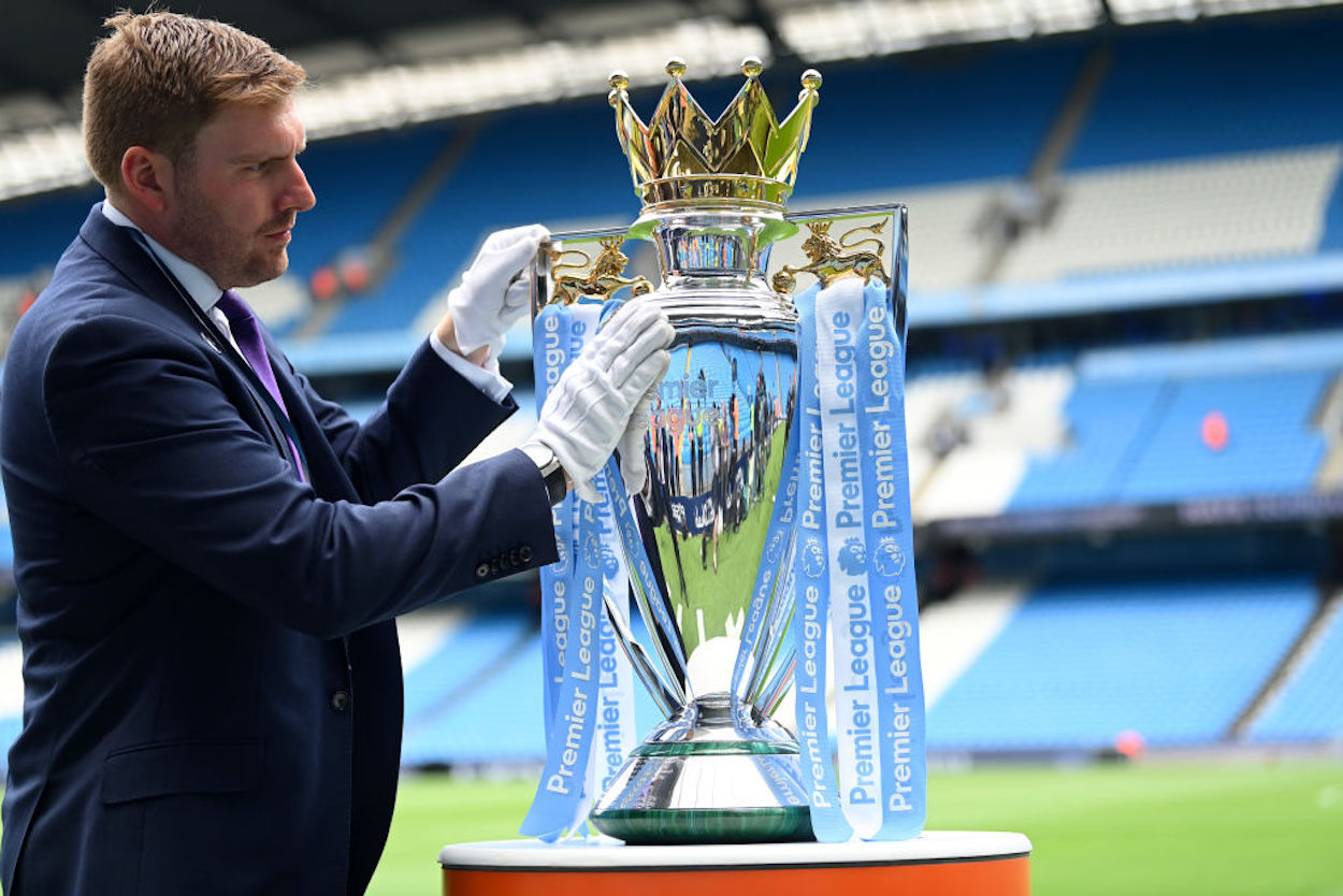 The Premier League Trophy is polished at the end of the 2021-22 season.