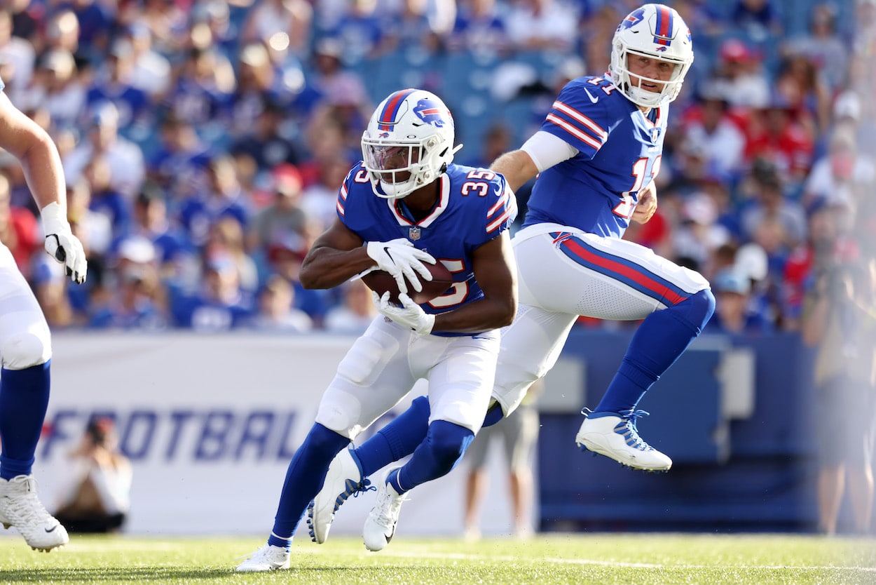 Raheem Blackshear of the Buffalo Bills takes the ball from Matt Barkley in a 2022 preseason game.