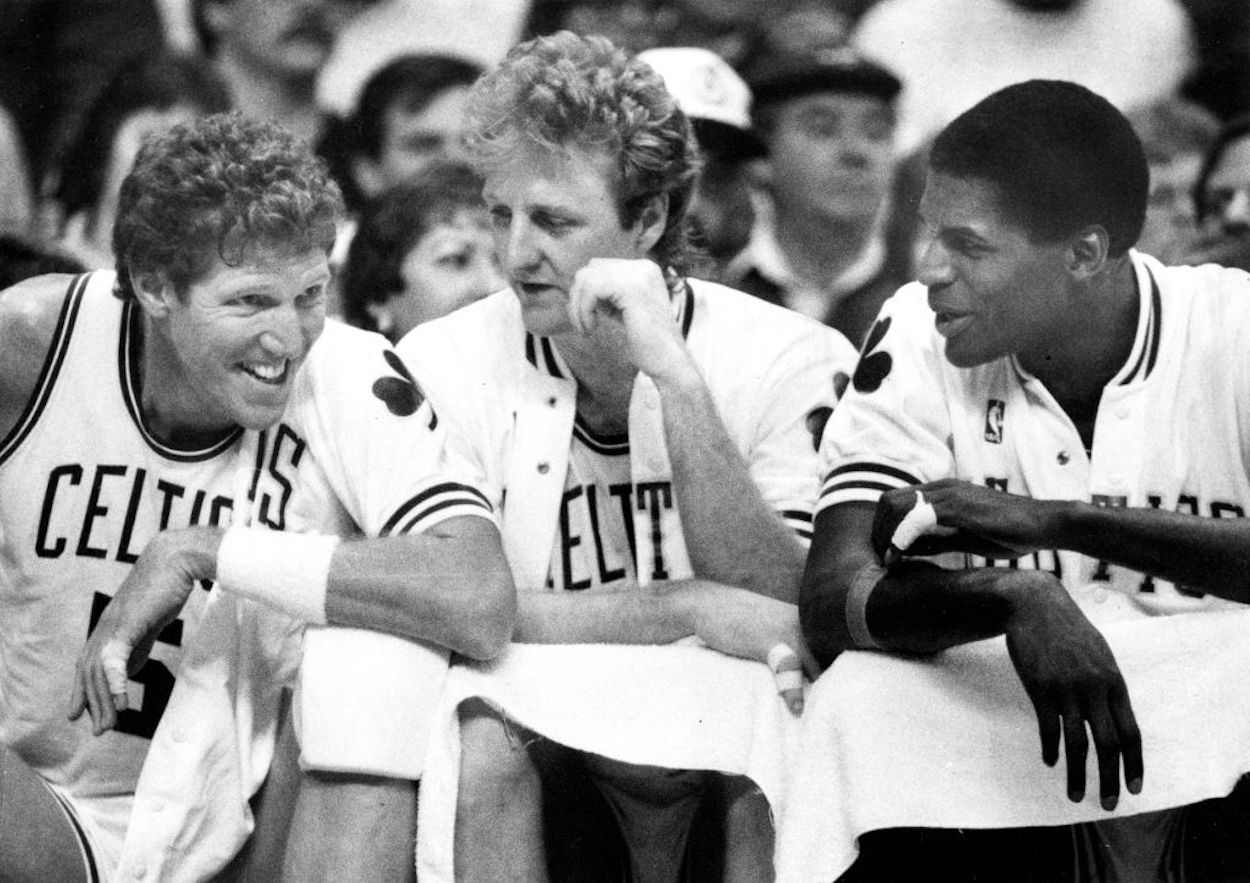 Bill Walton (L), Larry Bird (C), and Robert Parish (R) sitting on the Boston Celtics bench.