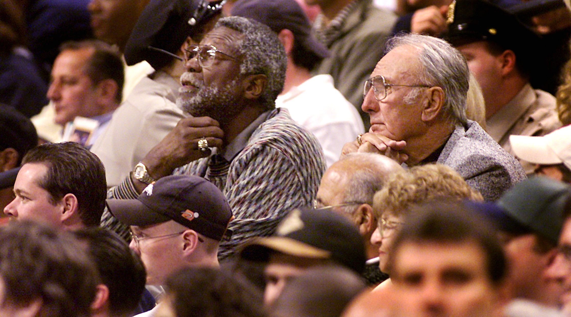 Boston Celtics greats Bill Russell, left, and Bob Cousy watch the action during a Celtics game.