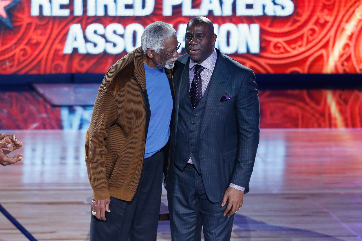 Former NBA players Bill Russell (L) and Earvin "Magic" Johnson Jr. are honored during the 2017 NBA All-Star Game.