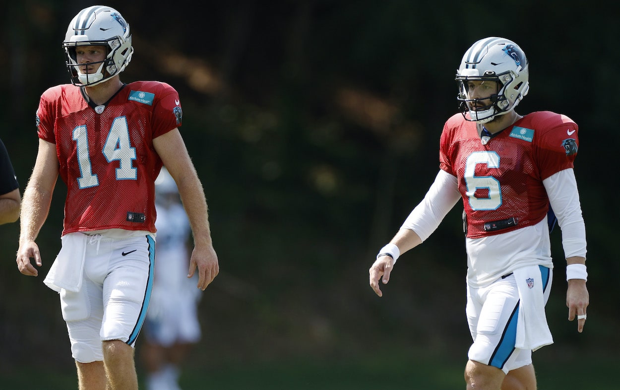 Sam Darnold and Baker Mayfield look on during training camp.