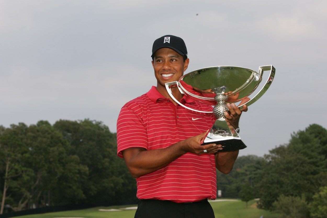 Tiger Woods poses with the FedEx Cup trophy.