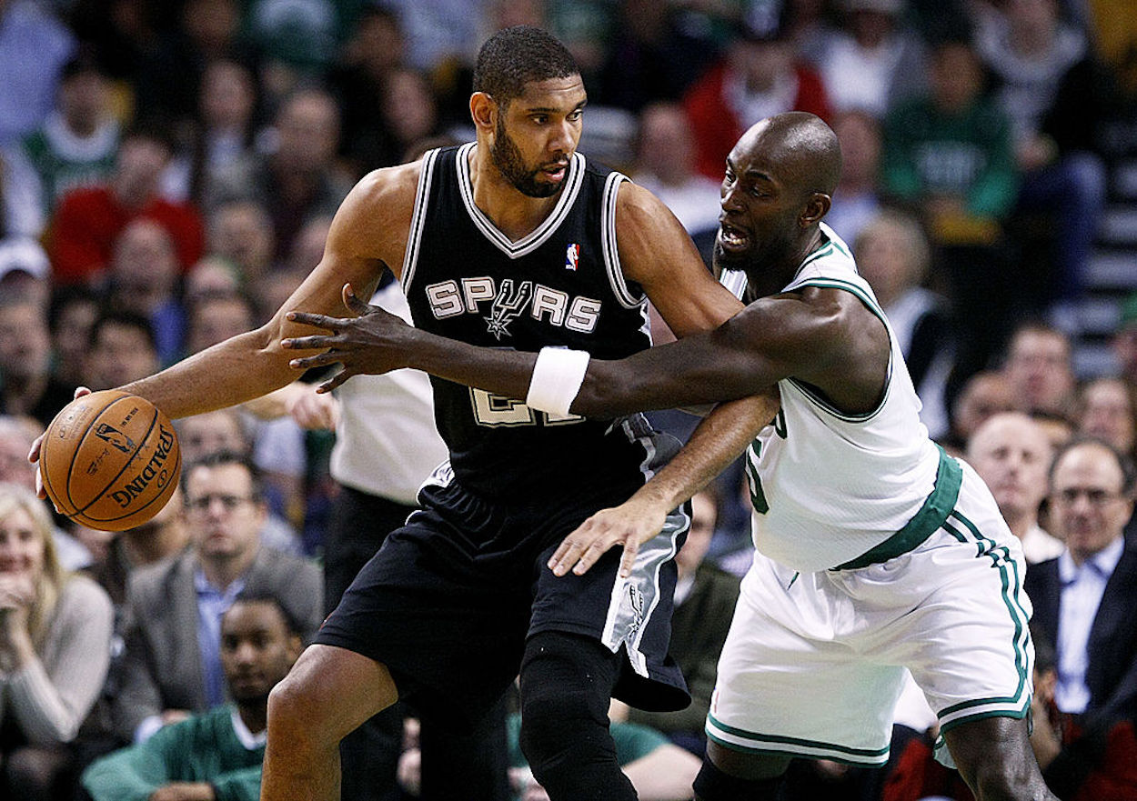 Tim Duncan (L) is defended by Kevin Garnett (R) during an NBA game.