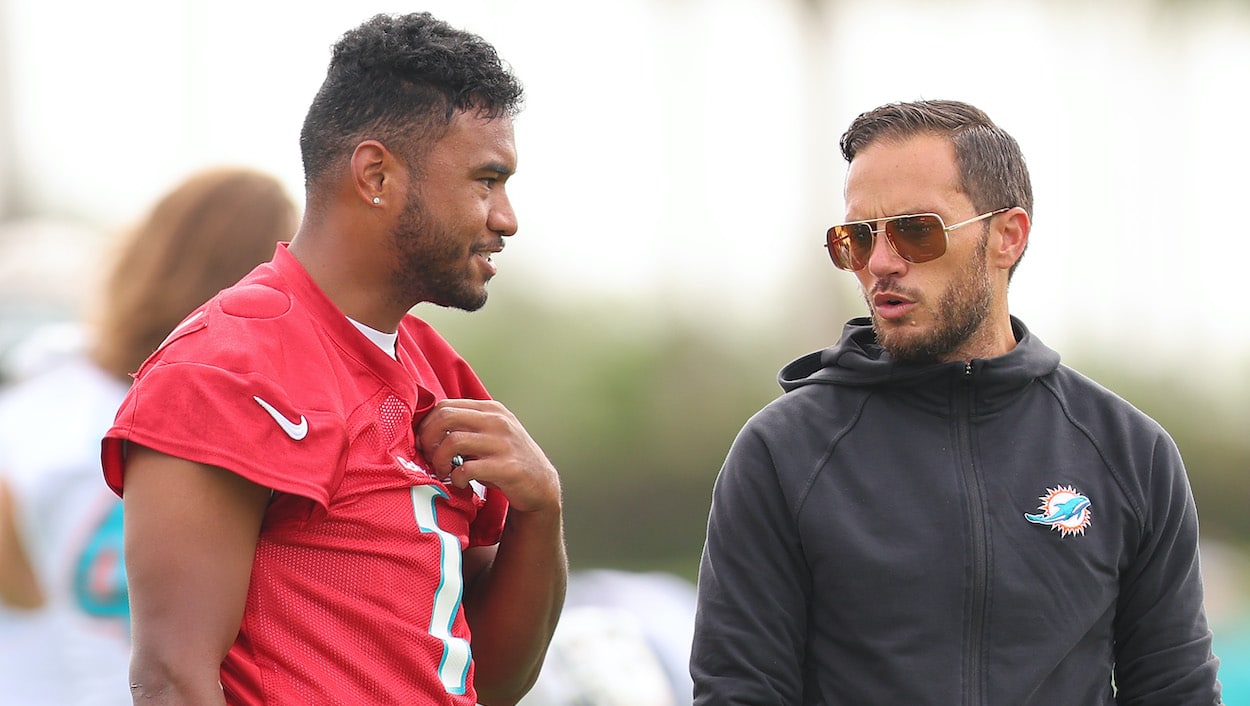 Head coach Mike McDaniel of the Miami Dolphins talks with Tua Tagovailoa during training camp.