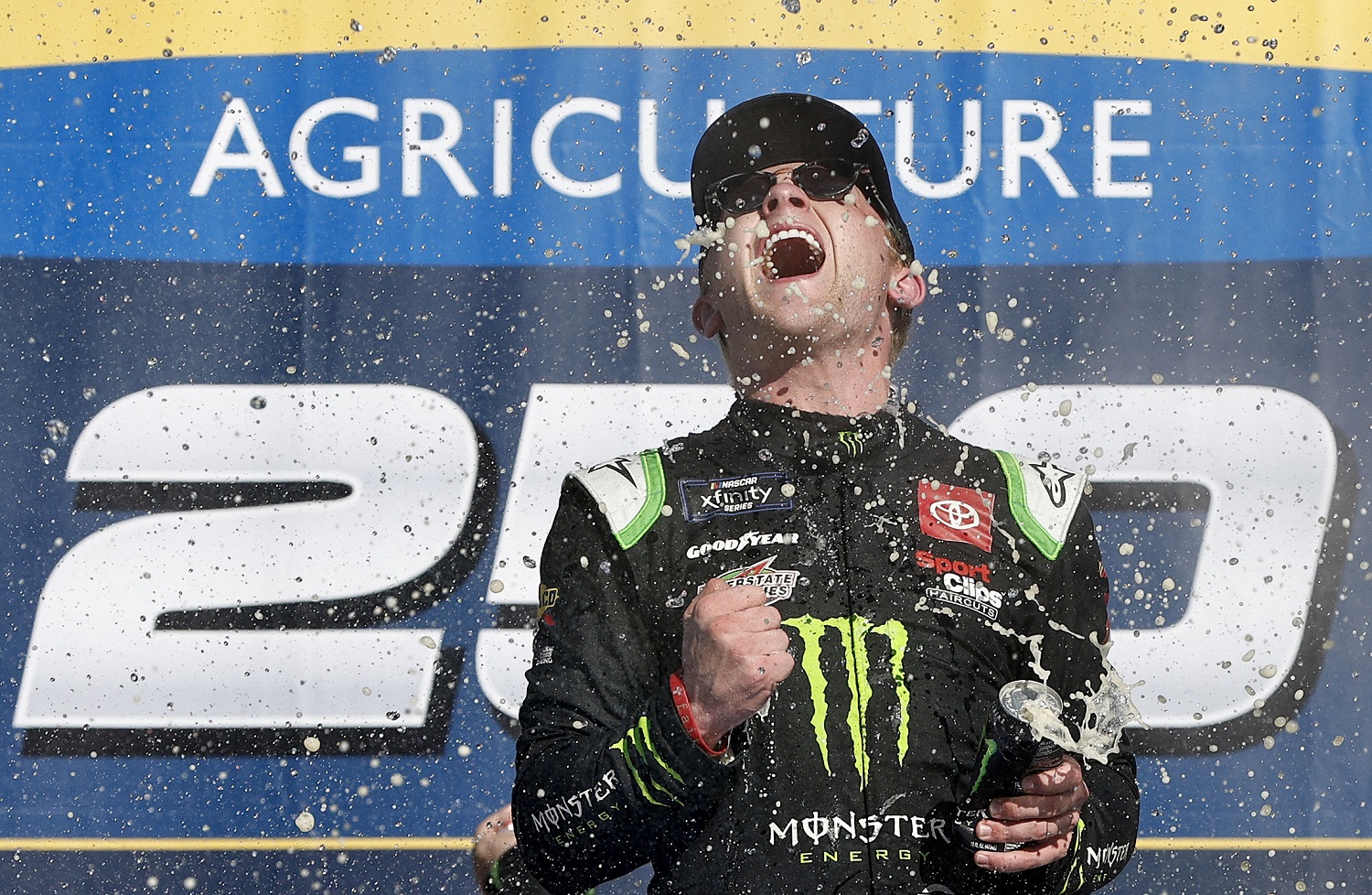 Ty Gibbs celebrates in Victory Lane after winning the NASCAR Xfinity Series New Holland 250 at Michigan International Speedway on Aug. 6, 2022.
