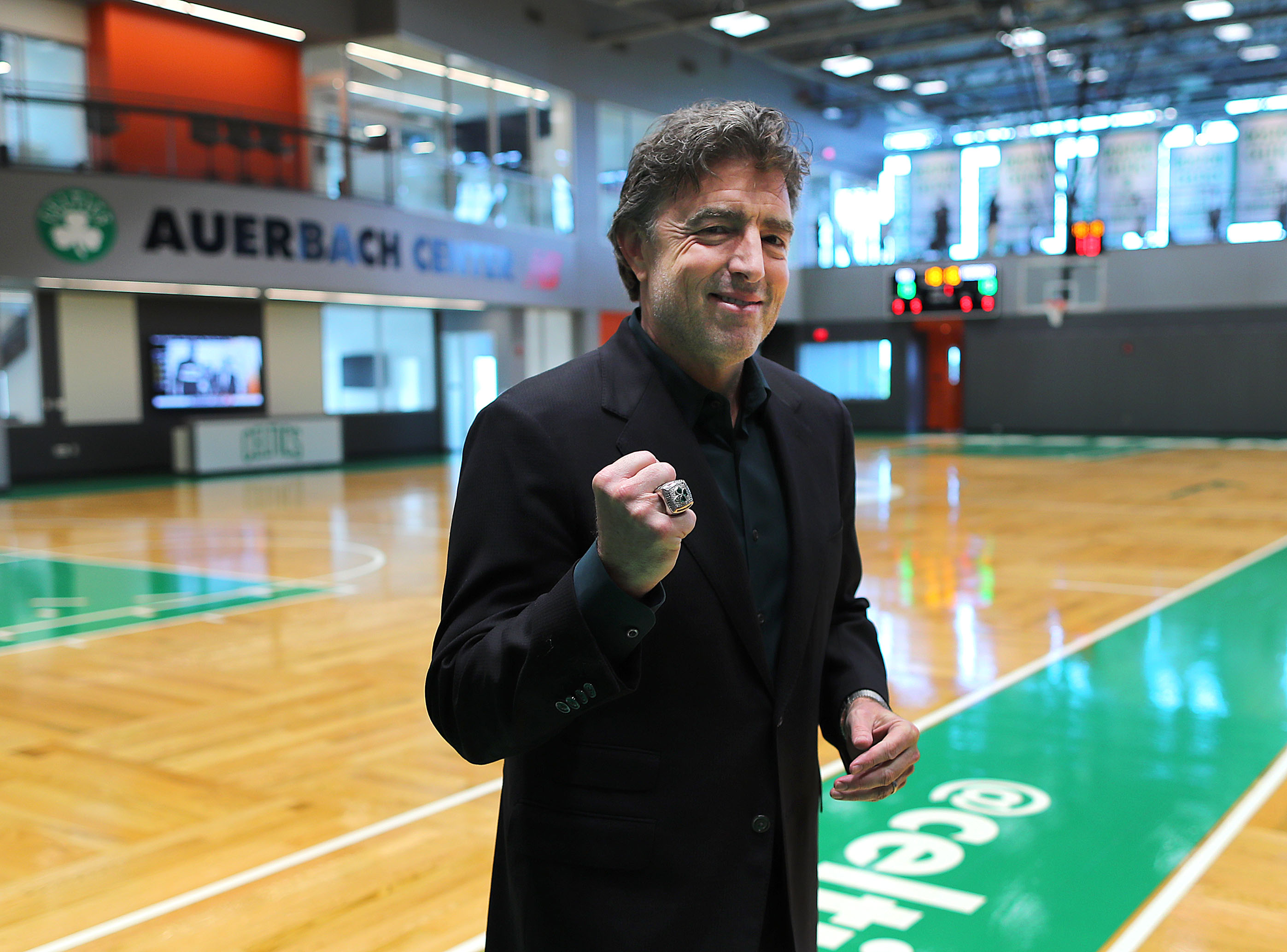 Boston Celtics CEO Wyc Grousbeck pumps his fist with a Celtics championship ring on his finger.
