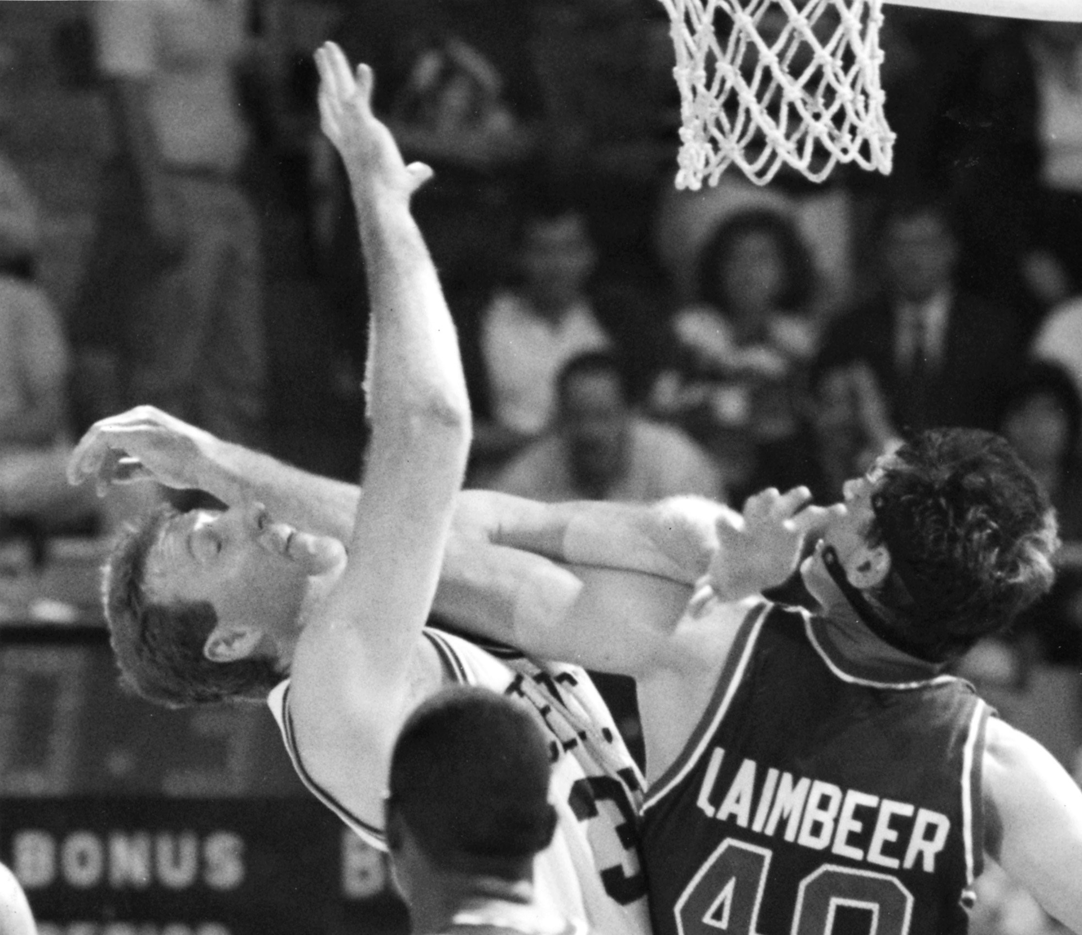 Boston Celtics forward Larry Bird takes an arm in the face from the Pistons Bill' Laimbeer.