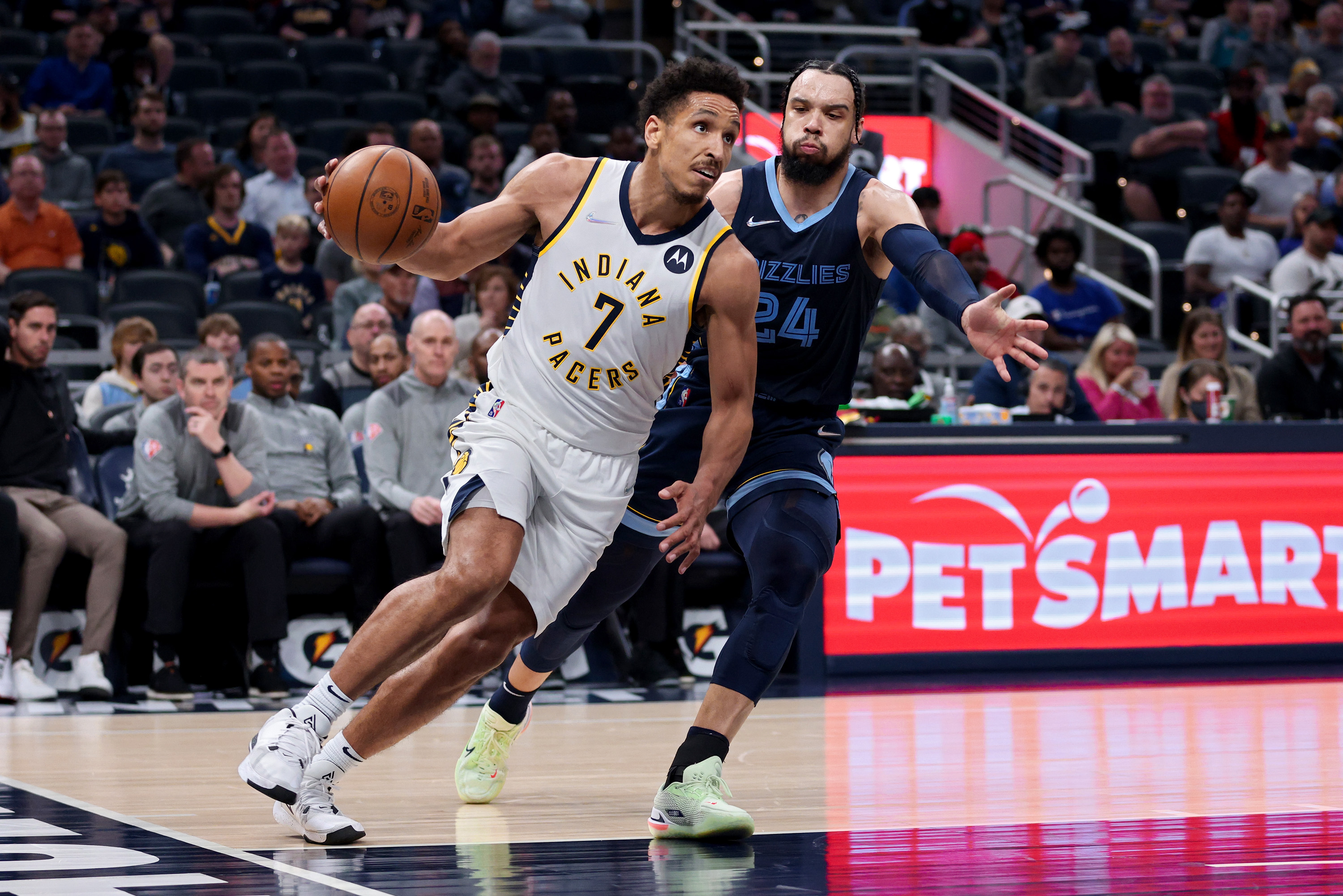 Malcolm Brogdon of the Indiana Pacers dribbles the ball while being guarded by Dillon Brooks of the Memphis Grizzlies.