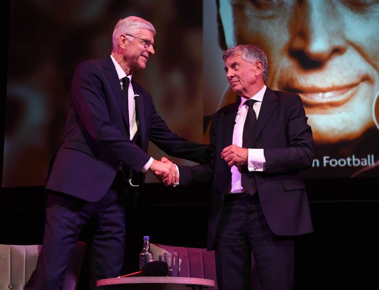 Former Arsenal vice Chairman David Dein (R) and former Arsenal manager Arsene Wenger (L) shake hands.