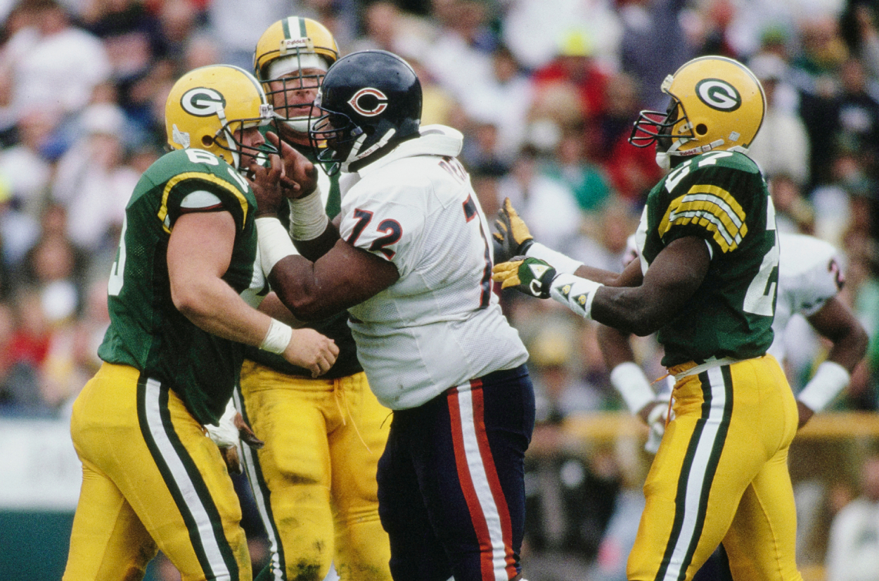 William the Refrigerator Perry grabs the face guard and points a finger at James Campen of the Green Bay Packers.