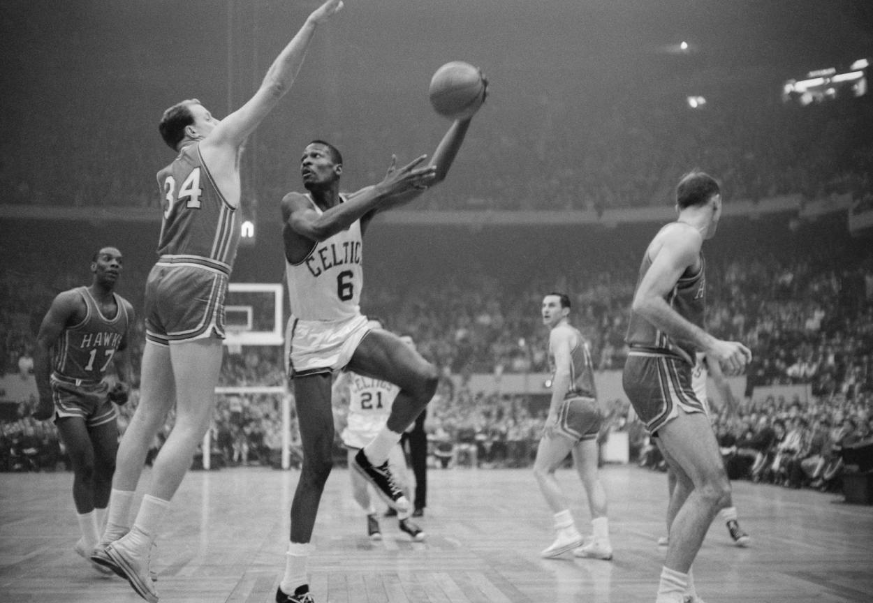 Boston Celtics center Bill Russell hooks a shot.