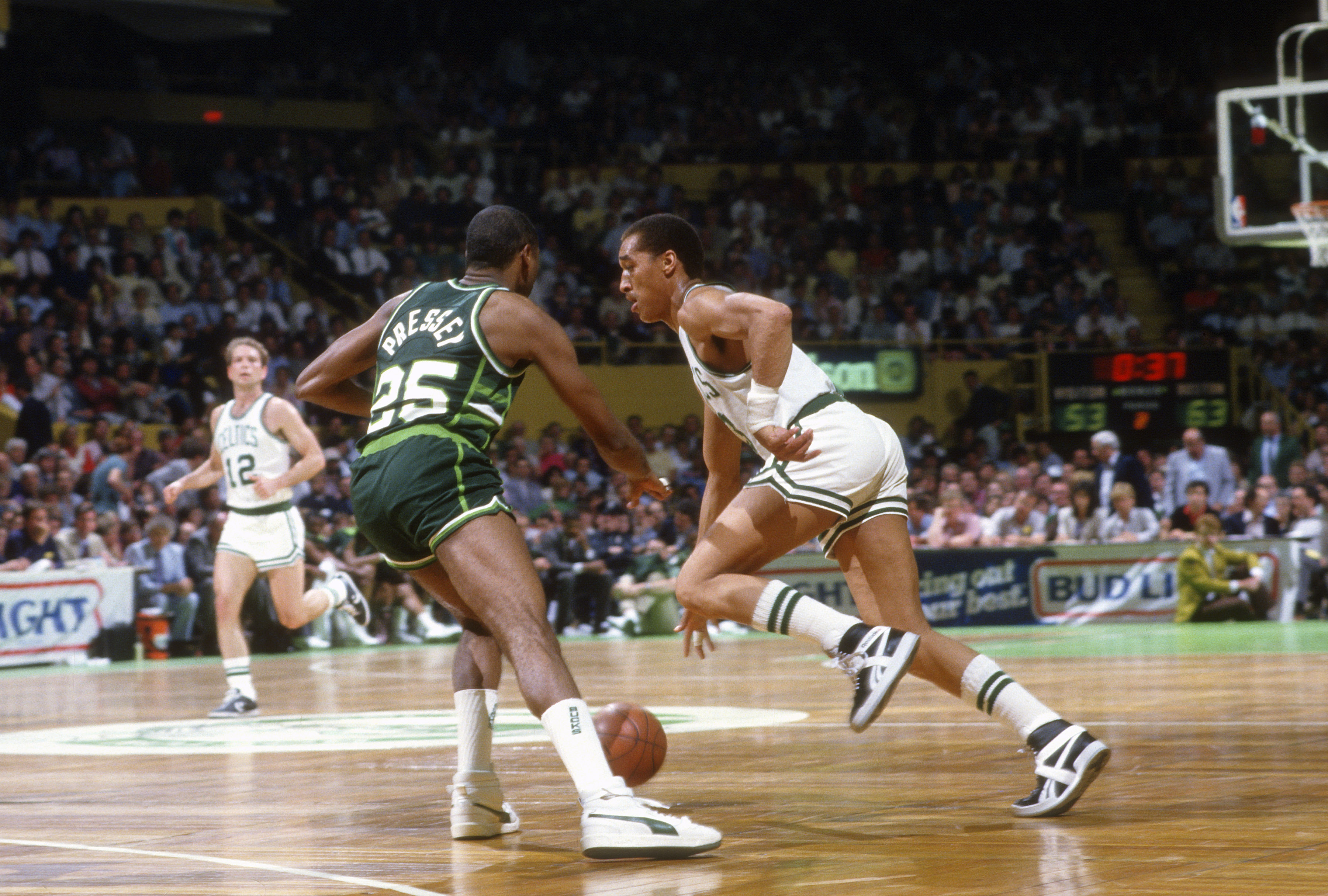 Dennis Johnson of the Boston Celtics drives on Paul Pressey of the Milwaukee Bucks during an NBA basketball game circa 1986 at the Boston Garden.