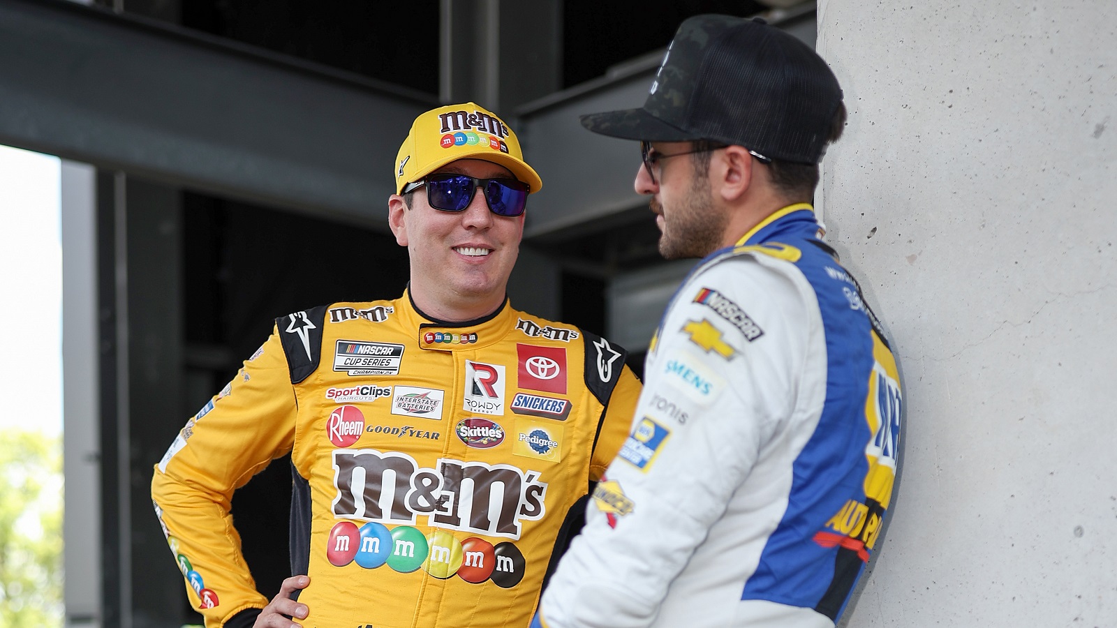 Kyle Busch and Chase Elliott talk prior to the NASCAR Cup Series Verizon 200 at the Brickyard at Indianapolis Motor Speedway on July 31, 2022.