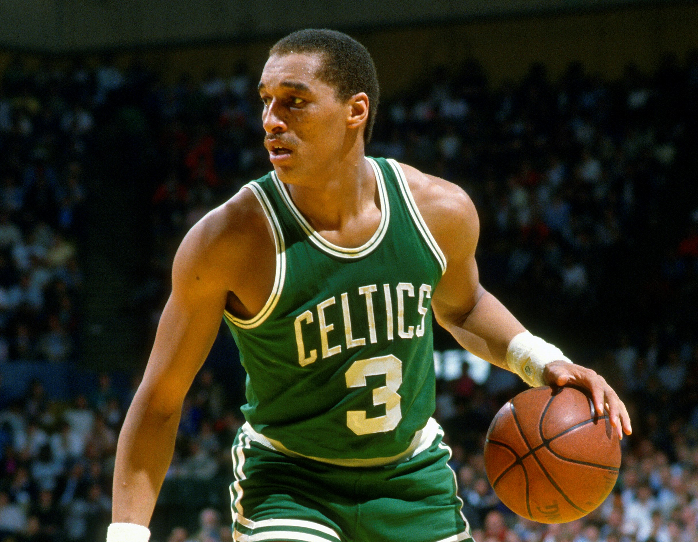 Dennis Johnson of the Boston Celtics dribbles the ball against the Milwaukee Bucks.