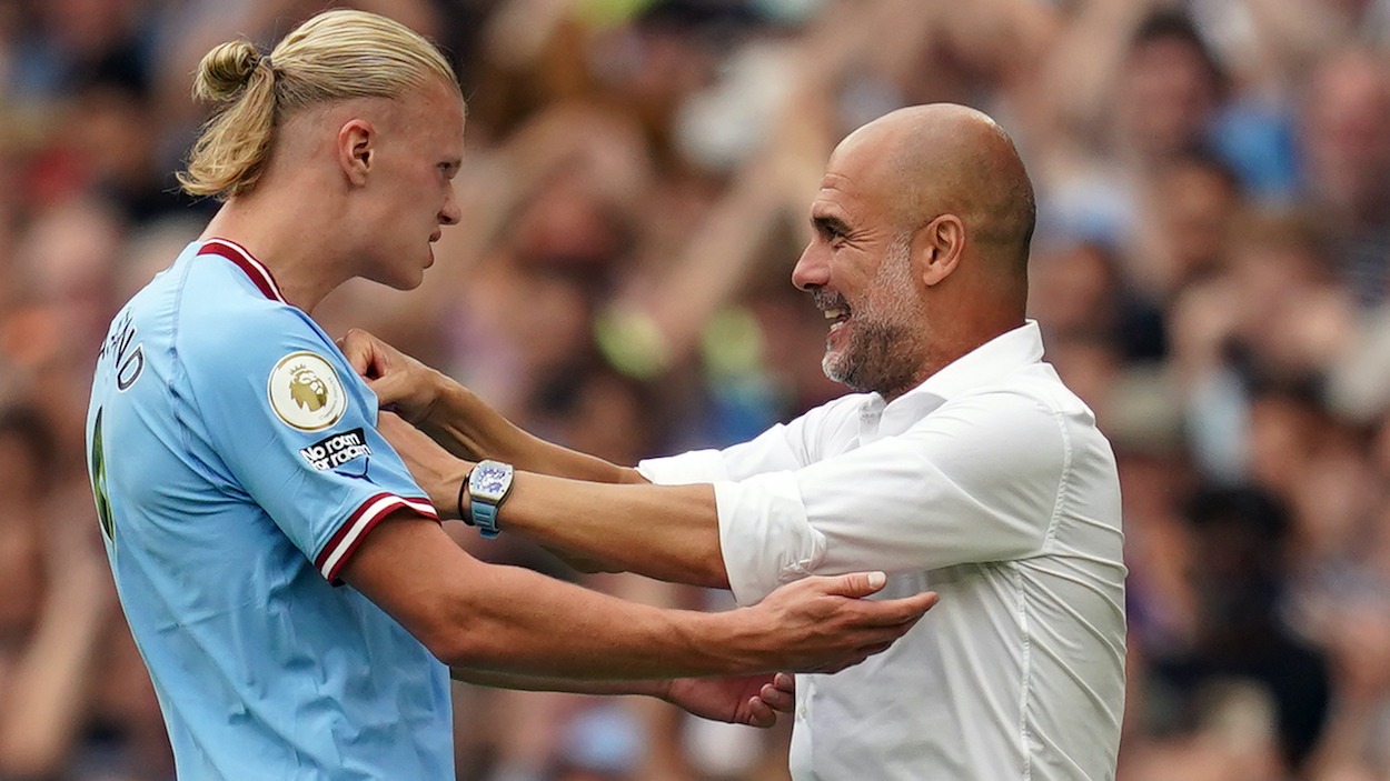 Manchester City striker Erling Haaland celebrates scoring his side fourth goal of the game to complete his hat trick with manager Pep Guardiola.