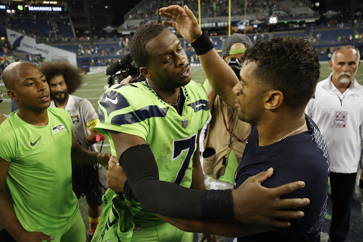 Russell Wilson of the Denver Broncos greets Seahawks quarterback Geno Smith after losing to Seattle