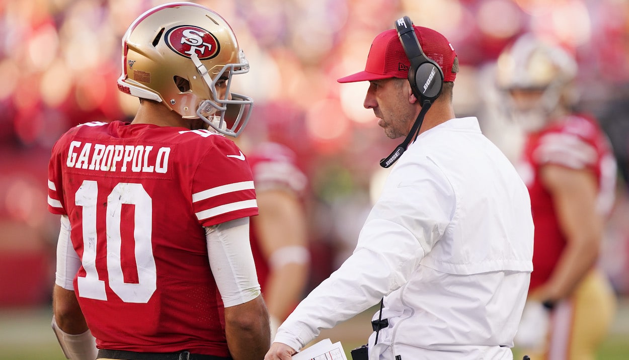 Jimmy Garoppolo speaks with head coach Kyle Shanahan of the San Francisco 49ers.