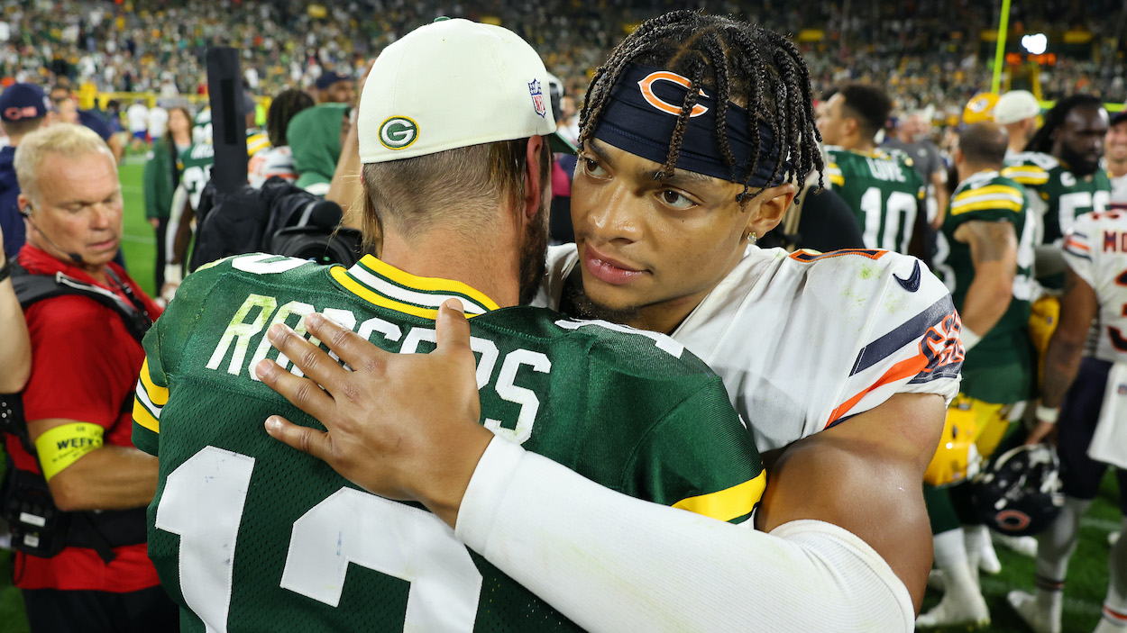 Justin Fields of the Chicago Bears hugs Aaron Rodgers of the Green Bay Packers.