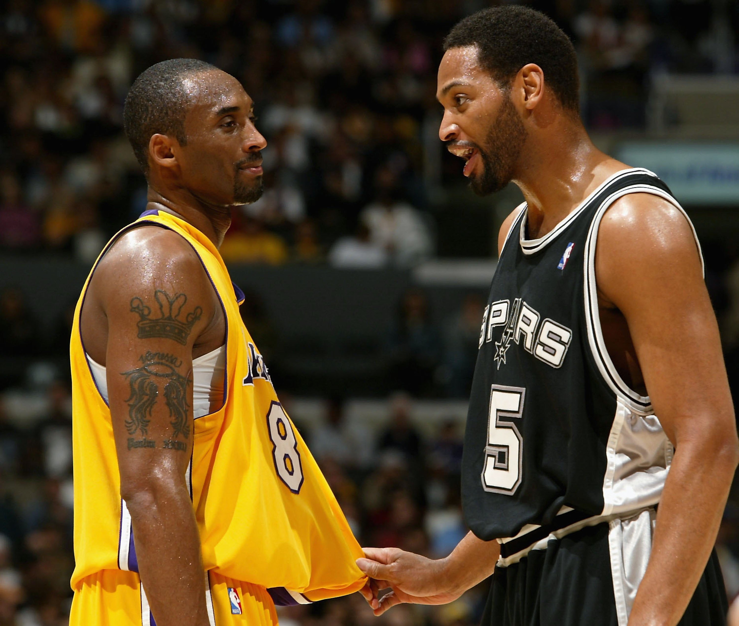 Robert Horry of the San Antonio Spurs and Kobe Bryant of the Los Angeles Lakers joke during a timeout.