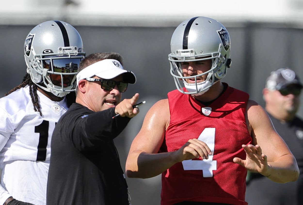 Davante Adams (L), Josh McDaniels (C), and Derek Carr (R) talk during training camp.