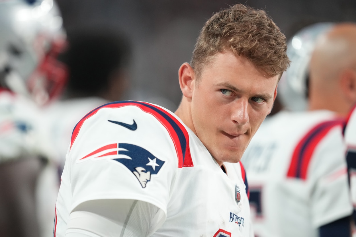 Quarterback Mac Jones of the New England Patriots looks on during the first half of a preseason game.