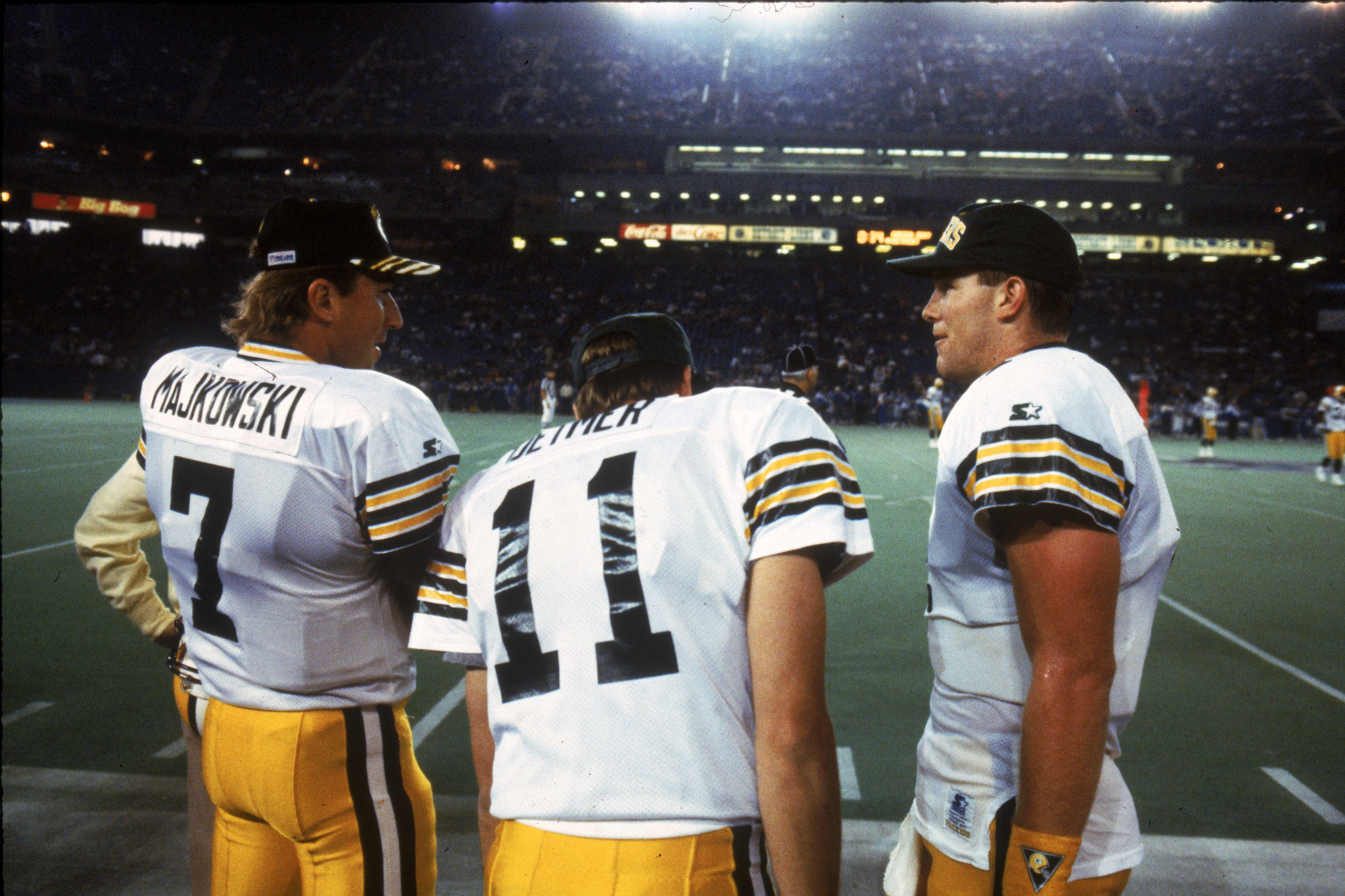 Quarterbacks Don Majkowski #7, Ty Detmer #11 and Brett Favre #4 of the Green Bay Packers talk on the sidelines.