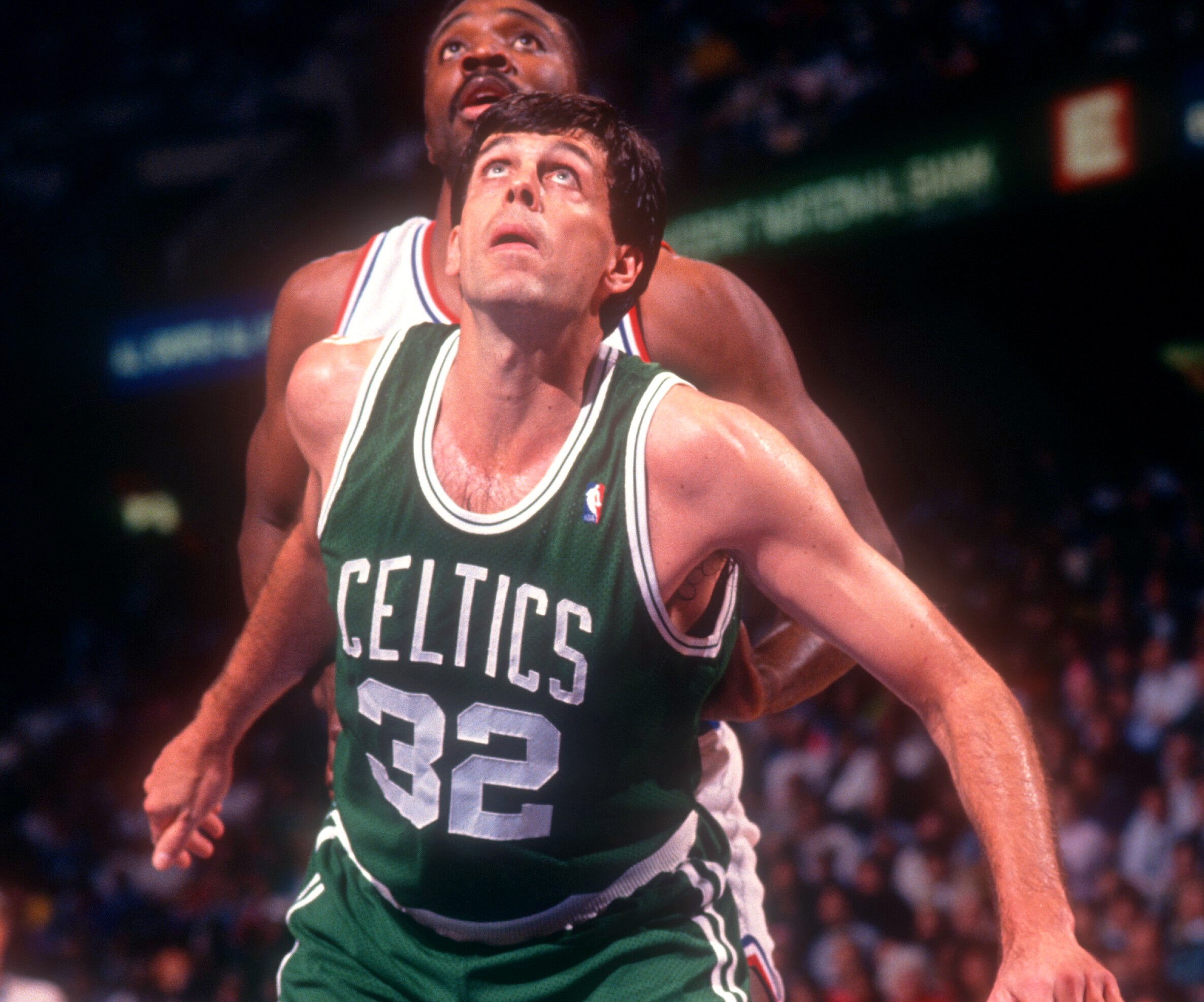 Kevin McHale of the Boston Celtics battles for position with Armen Gilliam of the Philadelphia 76ers .
