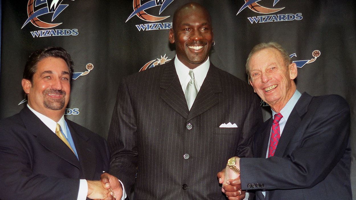 Washington Wizards owners Abe Pollin (R) and Ted Leonsis (L) pose with basketball legend Michael Jordan in 2000.