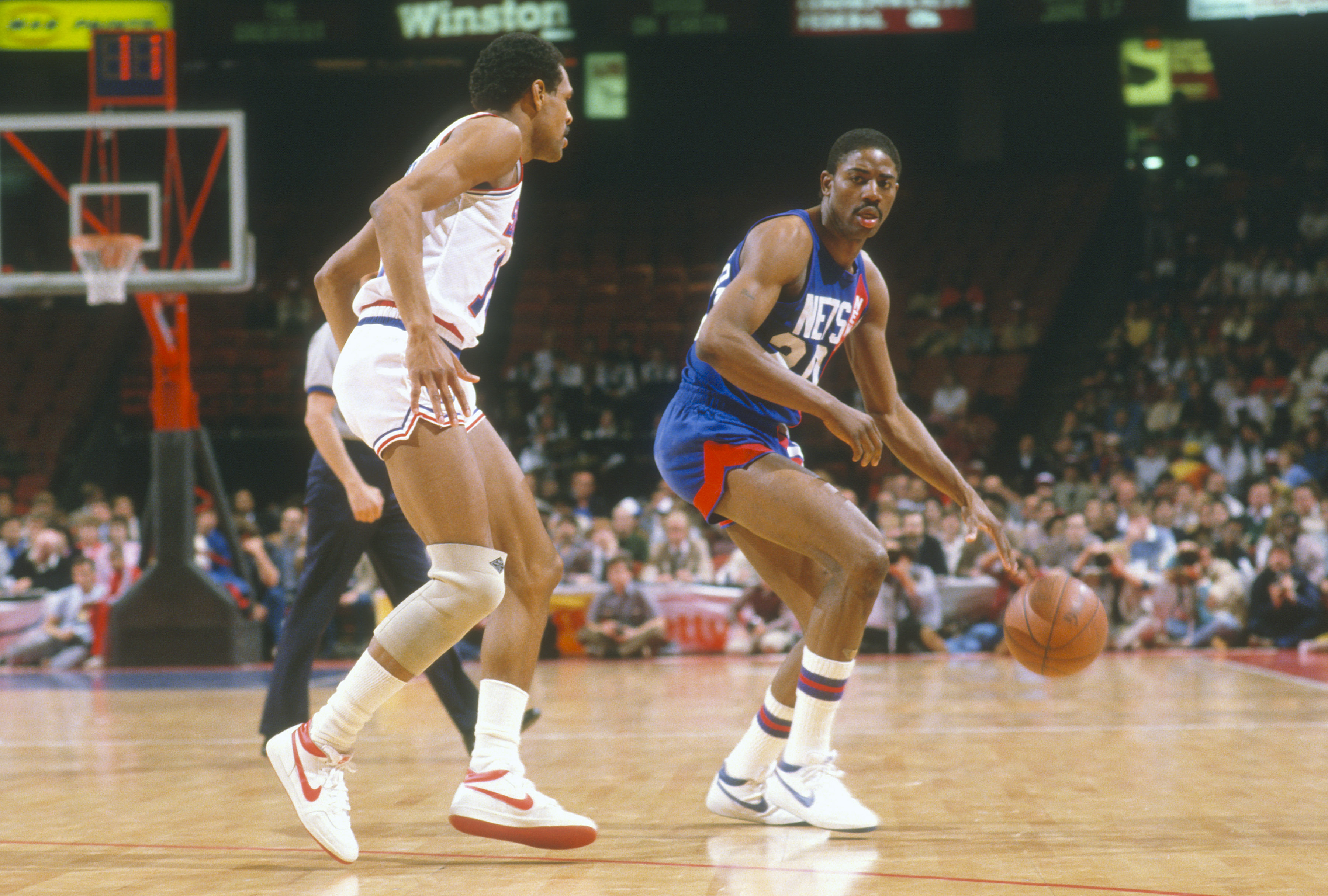 Michael Ray Richardson of the New Jersey Nets looks to put a move on Maurice Cheeks of the Philadelphia 76ers.
