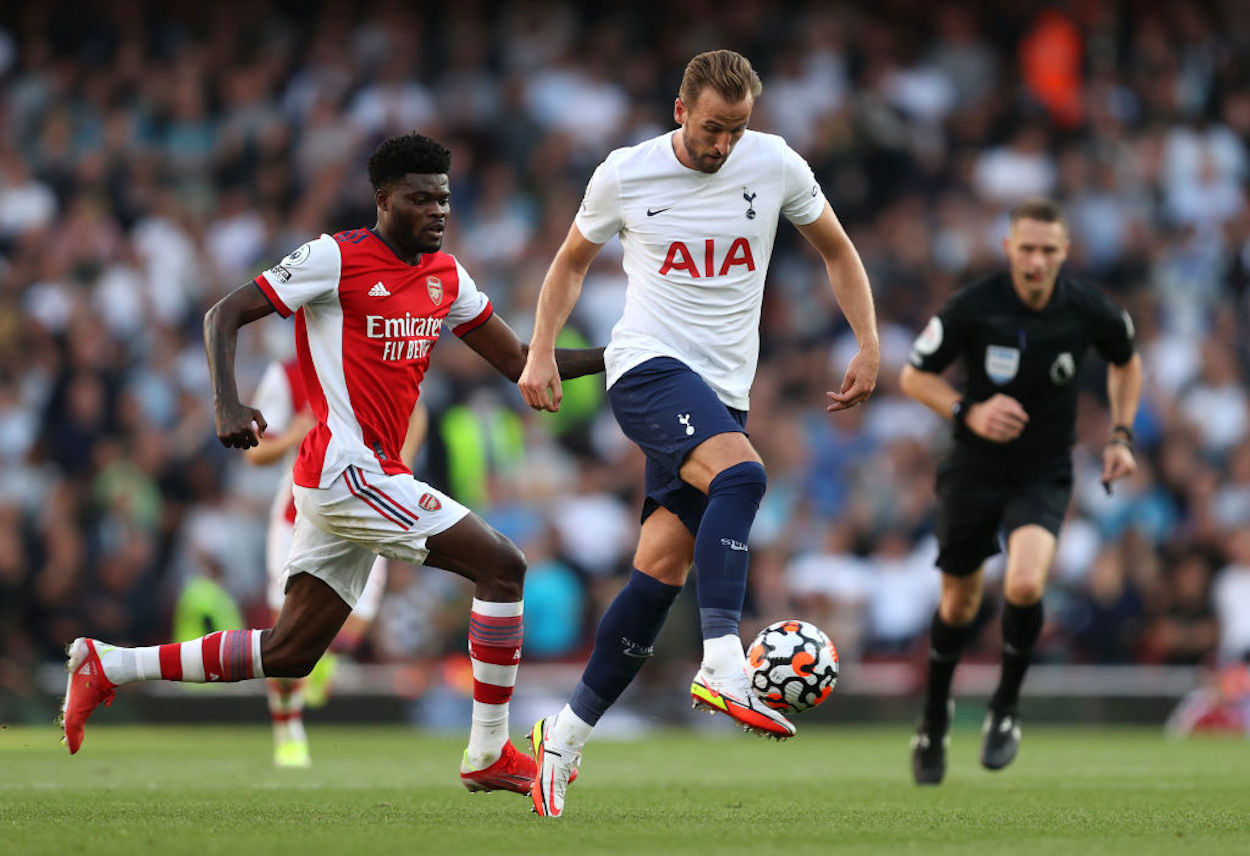 Tottenham's Harry Kane (R) holds off Arsenal's Thomas Partey (L) during a North London Derby.