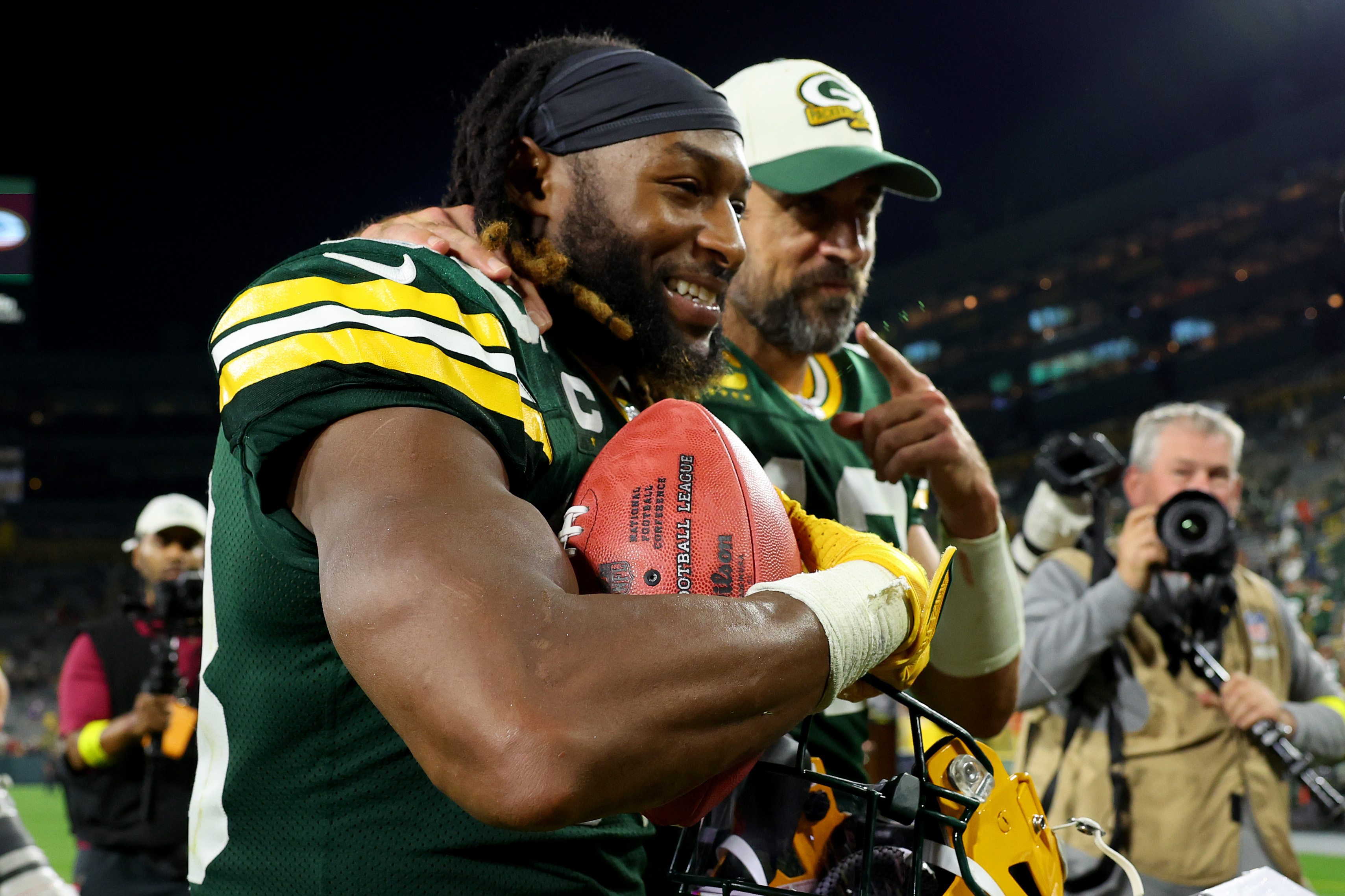 Aaron Jones and Aaron Rodgers of the Green Bay Packers walk off the field.