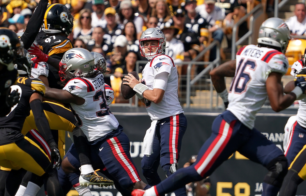 New England Patriots quarterback Mac Jones looks downfield for a receiver.