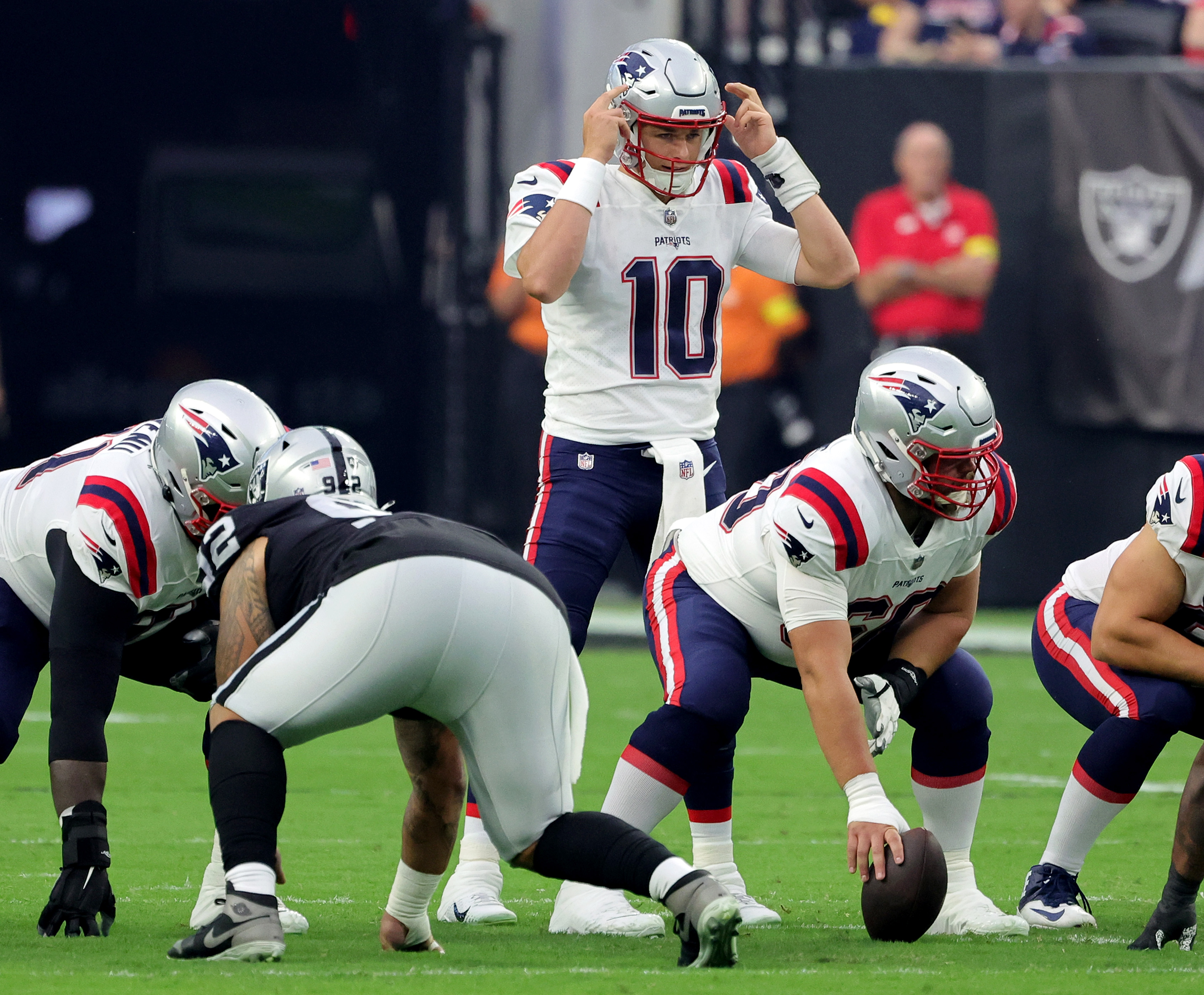 Quarterback Mac Jones of the New England Patriots calls out a play at the line of scrimmage.