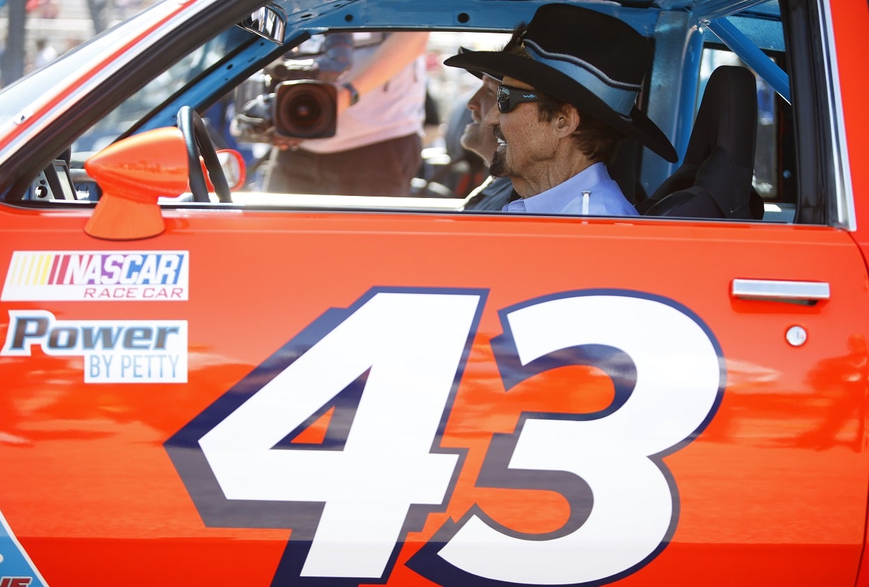 Richard Petty drives a replica of his No. 43 STP Pontiac in June 2022