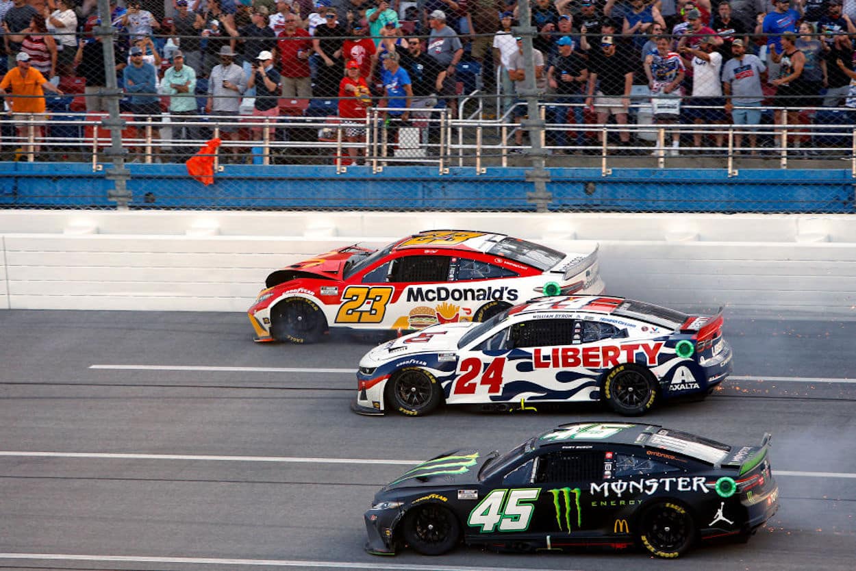 Bubba Wallace, William Byron, and Kurt Busch racing at Talladega.