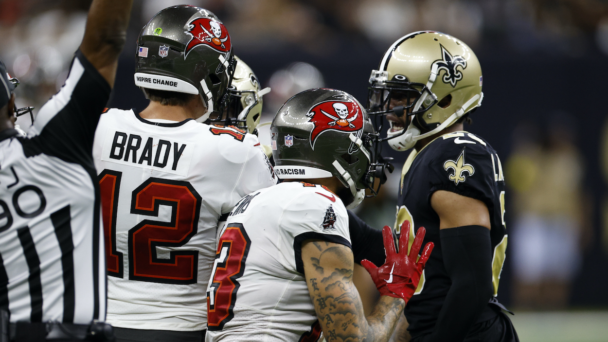 Mike Evans of the Tampa Bay Buccaneers pushes Marshon Lattimore of the New Orleans Saints in front of Tom Brady.
