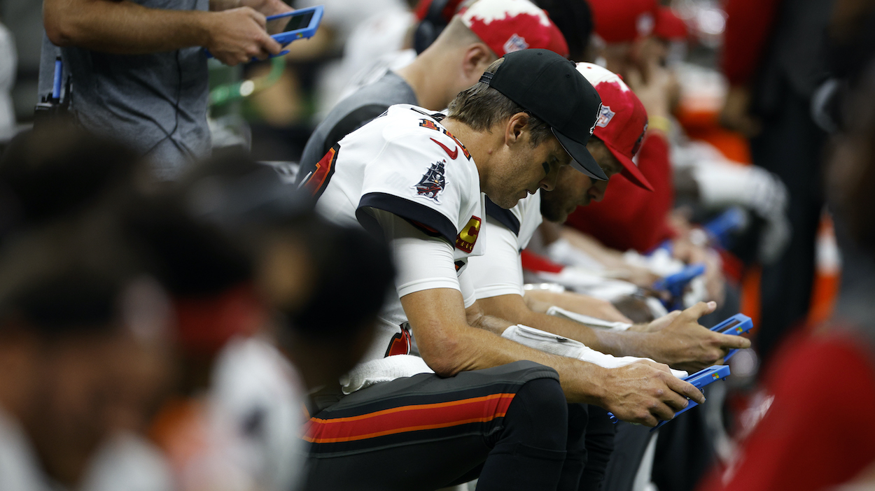 Tom Brady of the Tampa Bay Buccaneers looks at a tablet.