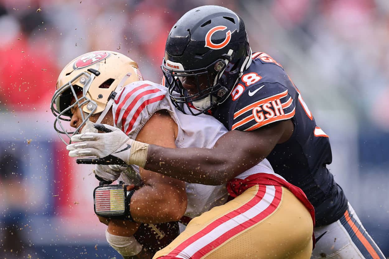 Trey Lance is tackled by Roquan Smith of the Chicago Bears.
