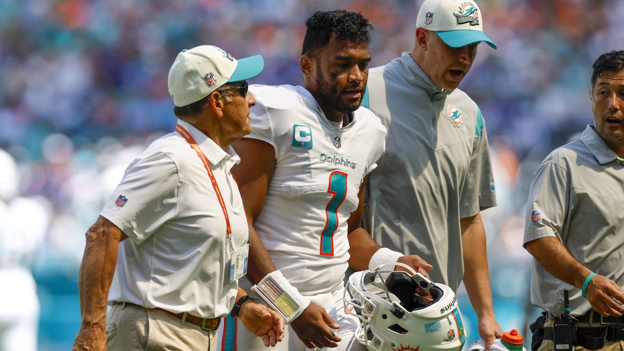 Miami Dolphins quarterback Tua Tagovailoa walks off the field with trainers in Week 3 vs. the Buffalo Bills.