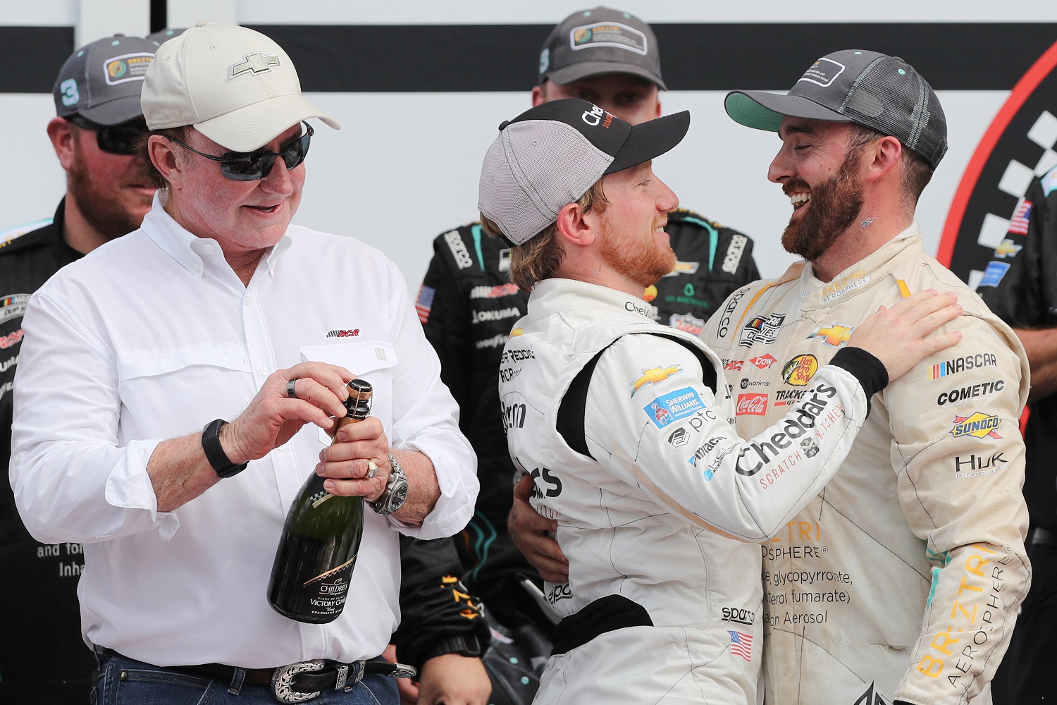 Austin Dillon is congratulated by Tyler Reddick as team owner Richard Childress looks on after the NASCAR Cup Series Coke Zero Sugar 400 at Daytona International Speedway on Aug. 28, 2022.