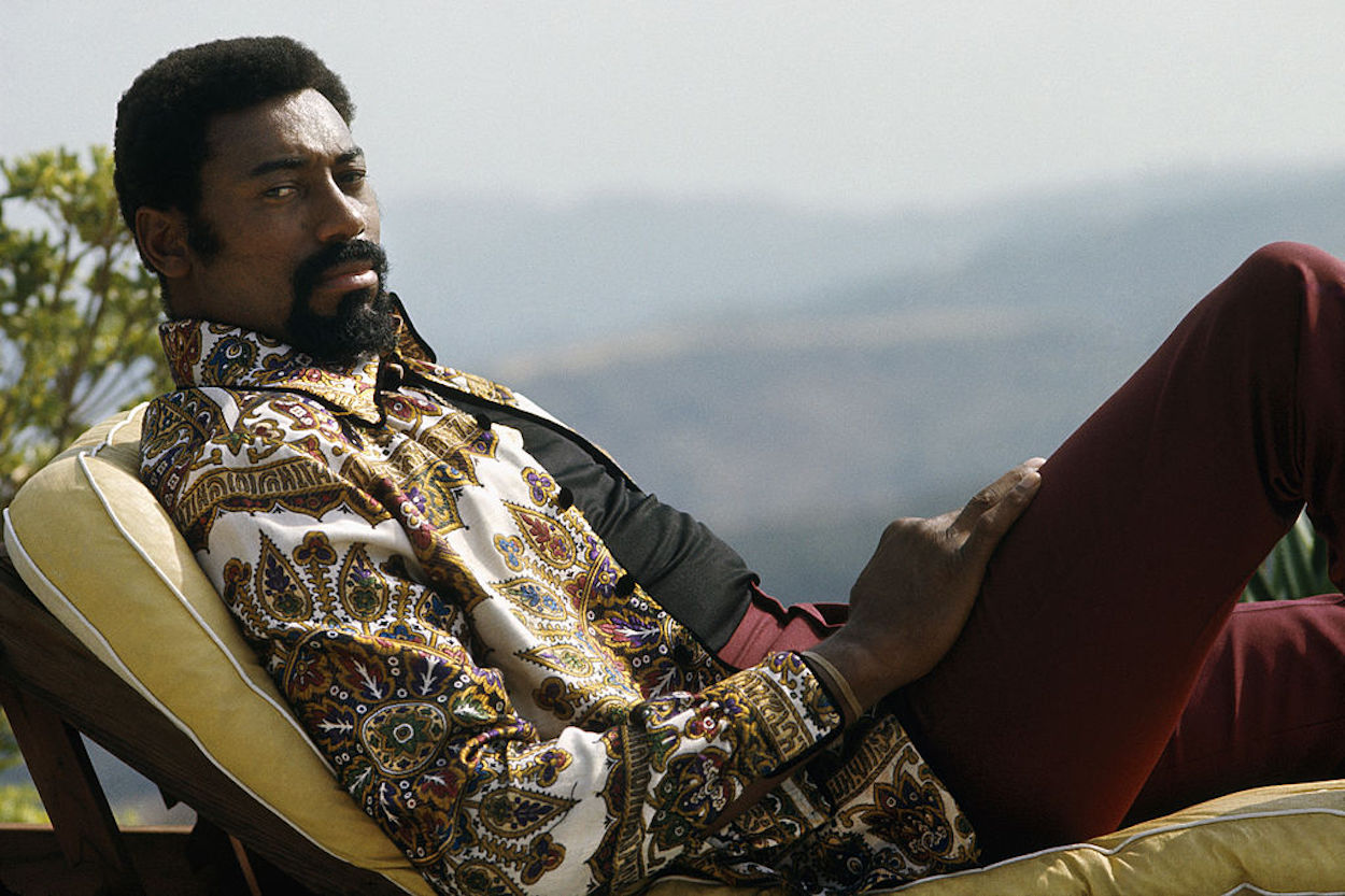 NBA legend Wilt Chamberlain lounges in his back yard.