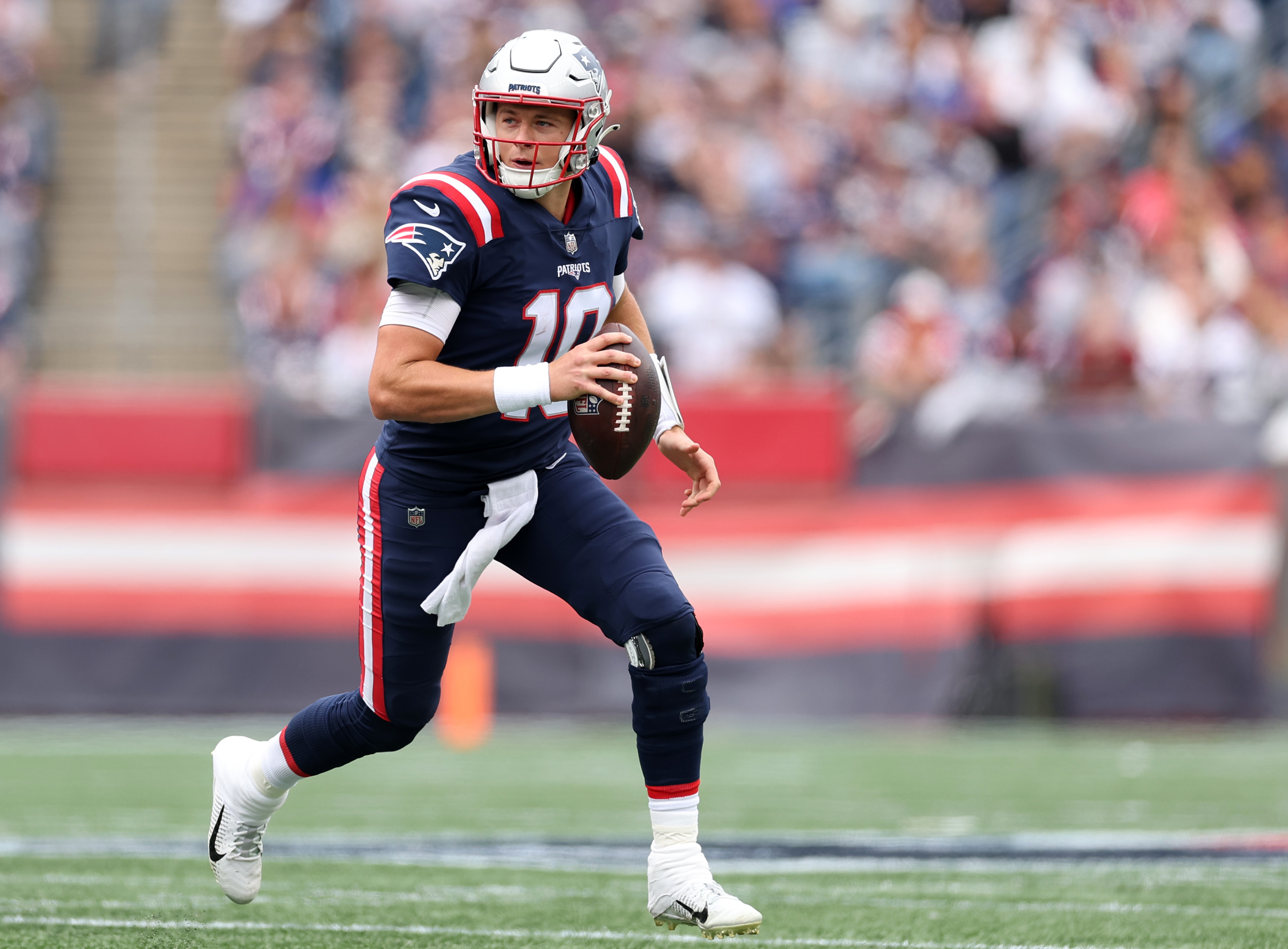 Mac Jones of the New England Patriots rushes against the Baltimore Ravens.