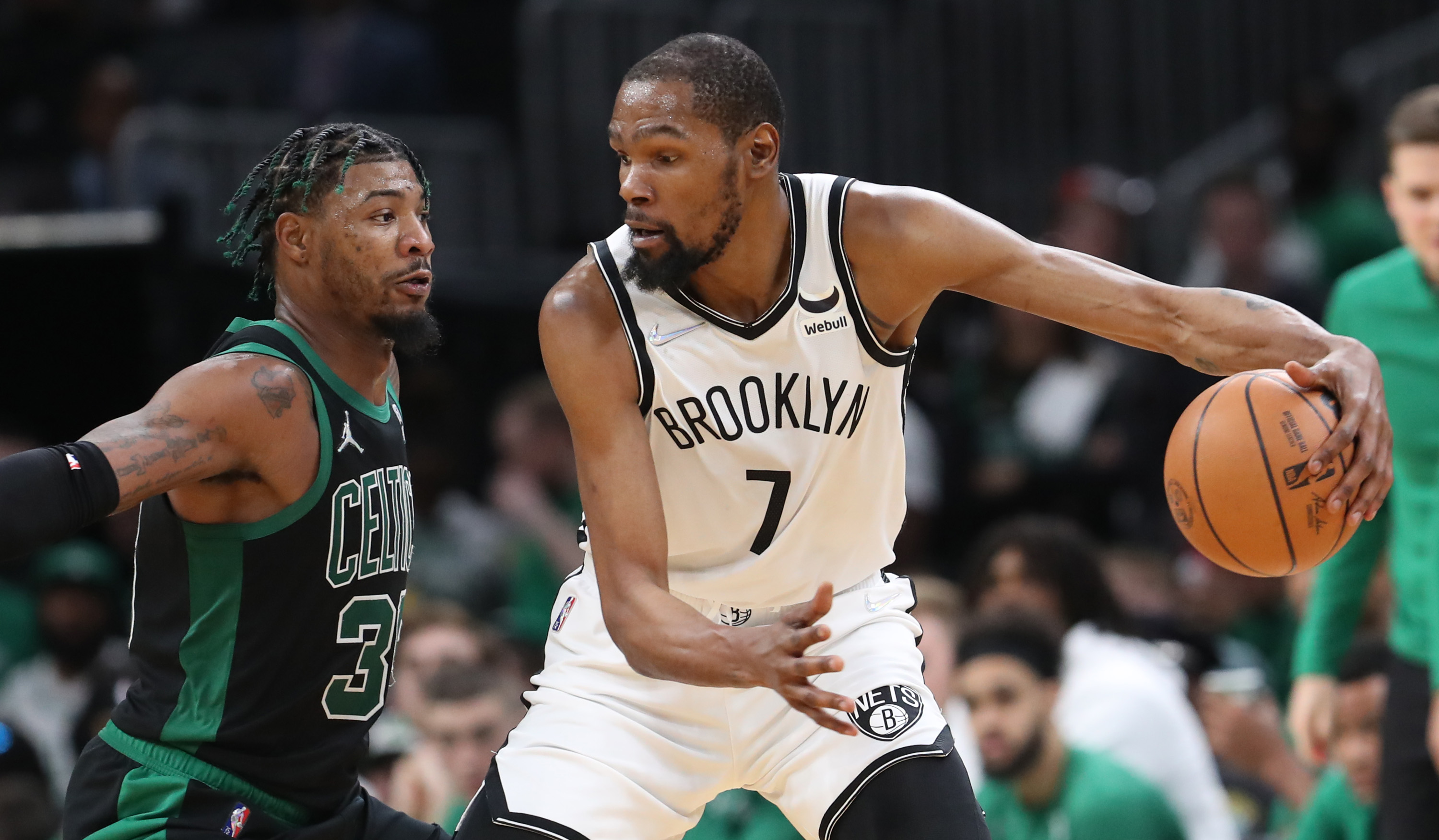 Brooklyn Nets forward Kevin Durant drives past Boston Celtics guard Marcus Smart.