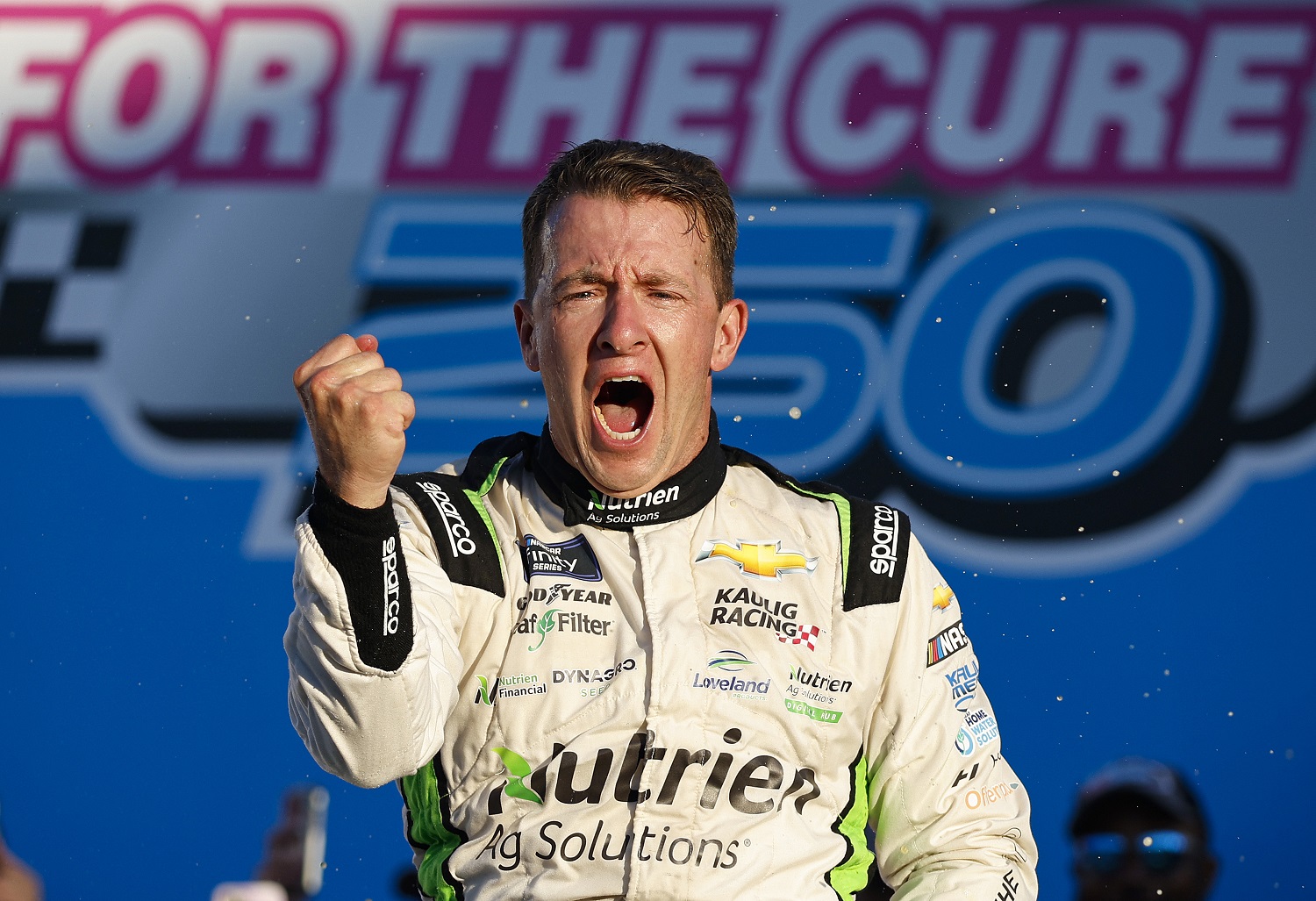 AJ Allmendinger celebrates in Victory Lane after winning the NASCAR Xfinity Series Drive for the Cure 250 at Charlotte Motor Speedway on Oct. 8, 2022, in Concord, North Carolina.