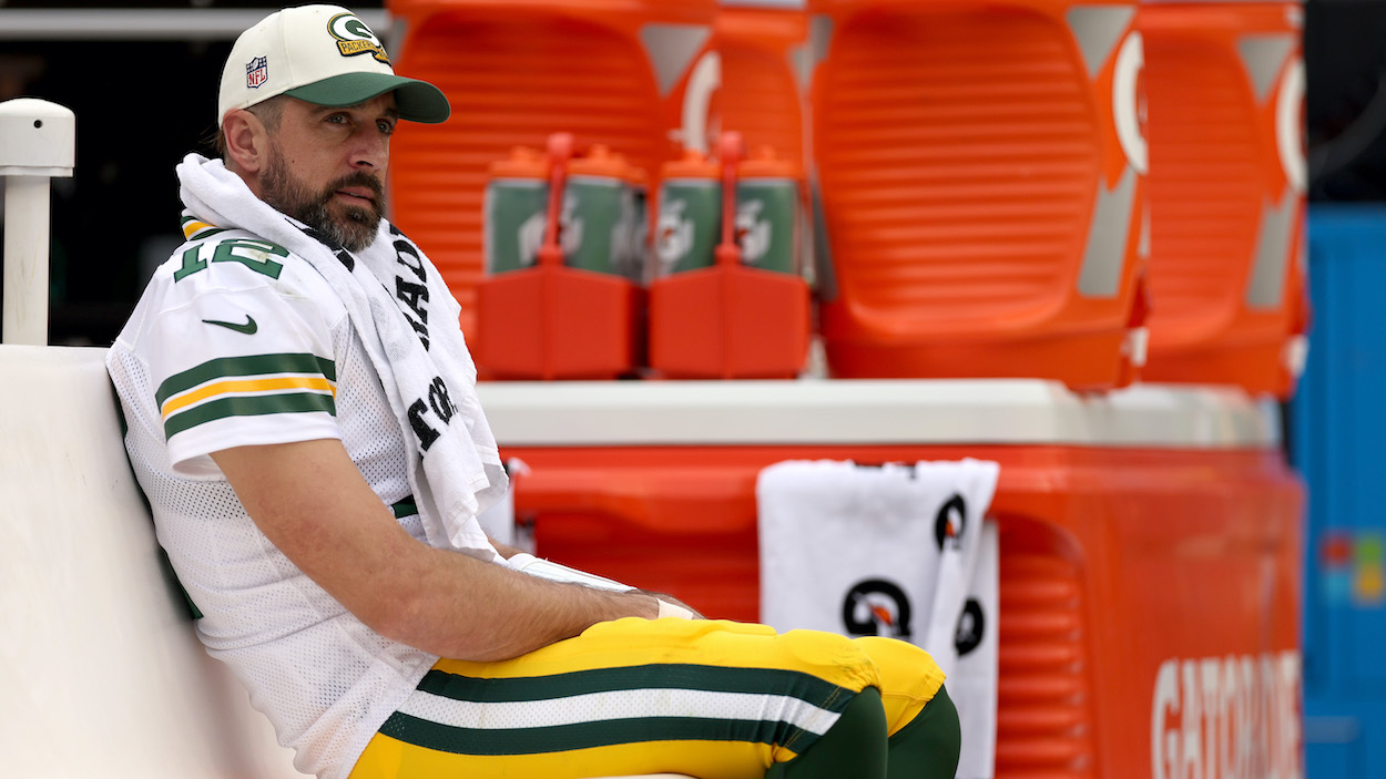 Aaron Rodgers of the Green Bay Packers looks on from the bench during the third quarter of the game against the Washington Commanders.