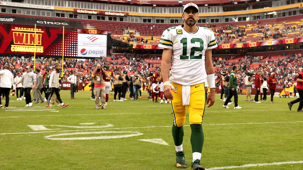 Aaron Rodgers of the Green Bay Packers walks off the field after the game against the Washington Commanders.